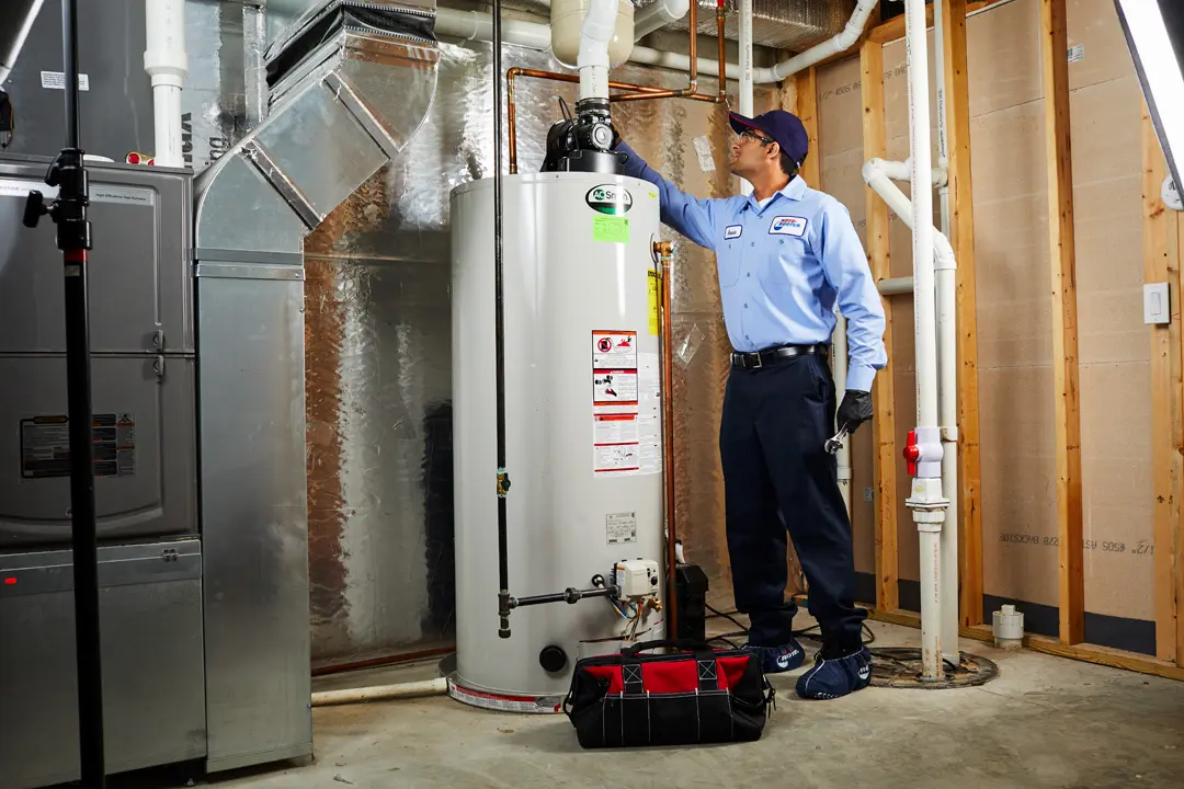 Roto-Rooter technician servicing a water heater in an Apple Valley home