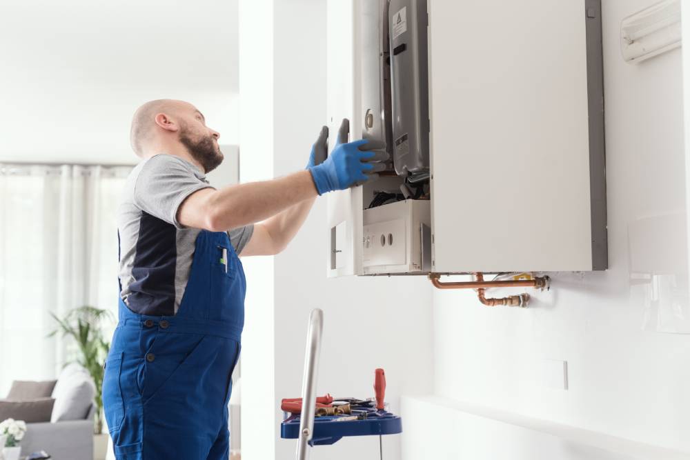 Technician repairing a water heater system.